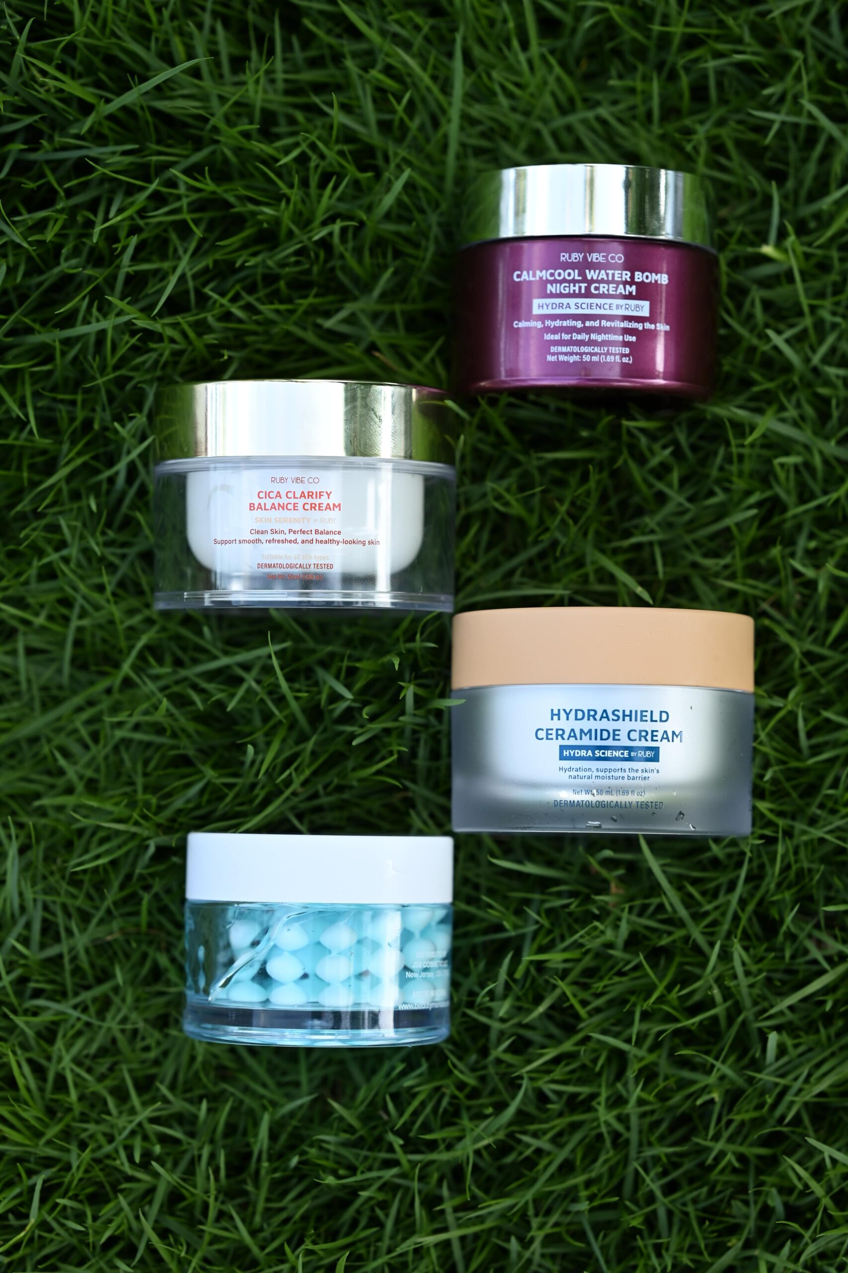 A flat lay of 'Ruby Vibe Co' skincare creams, including a calmcool water bomb and ceramide cream, representing the prep for a glowing, office-ready look.