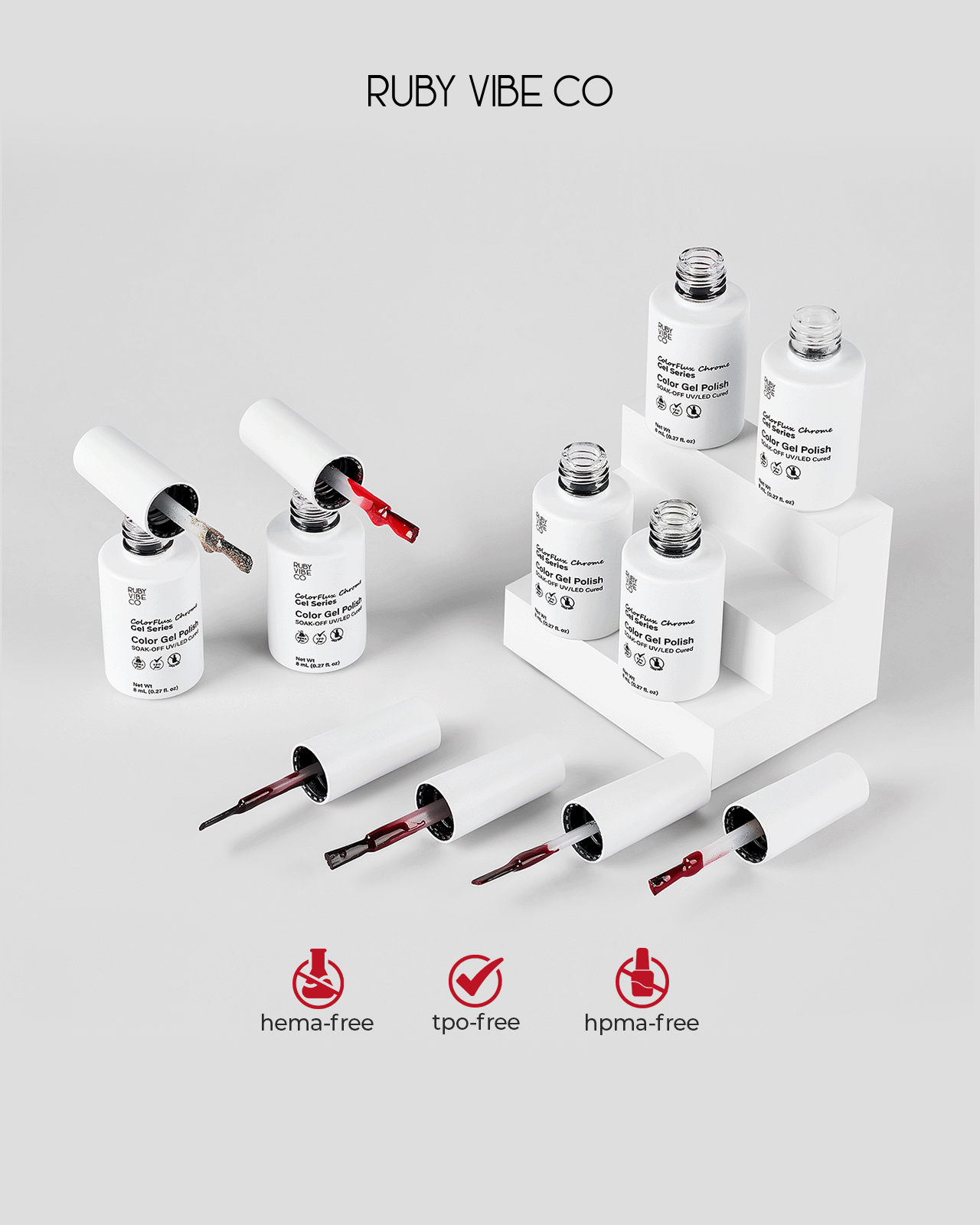 A product shot of a set of 'Ruby Vibe Co' Color Gel Polish bottles, with some brushes extended to show various shades of red and pink. The image highlights the hema-free and tpo-free benefits, ideal for safe and DIY gel nail art.