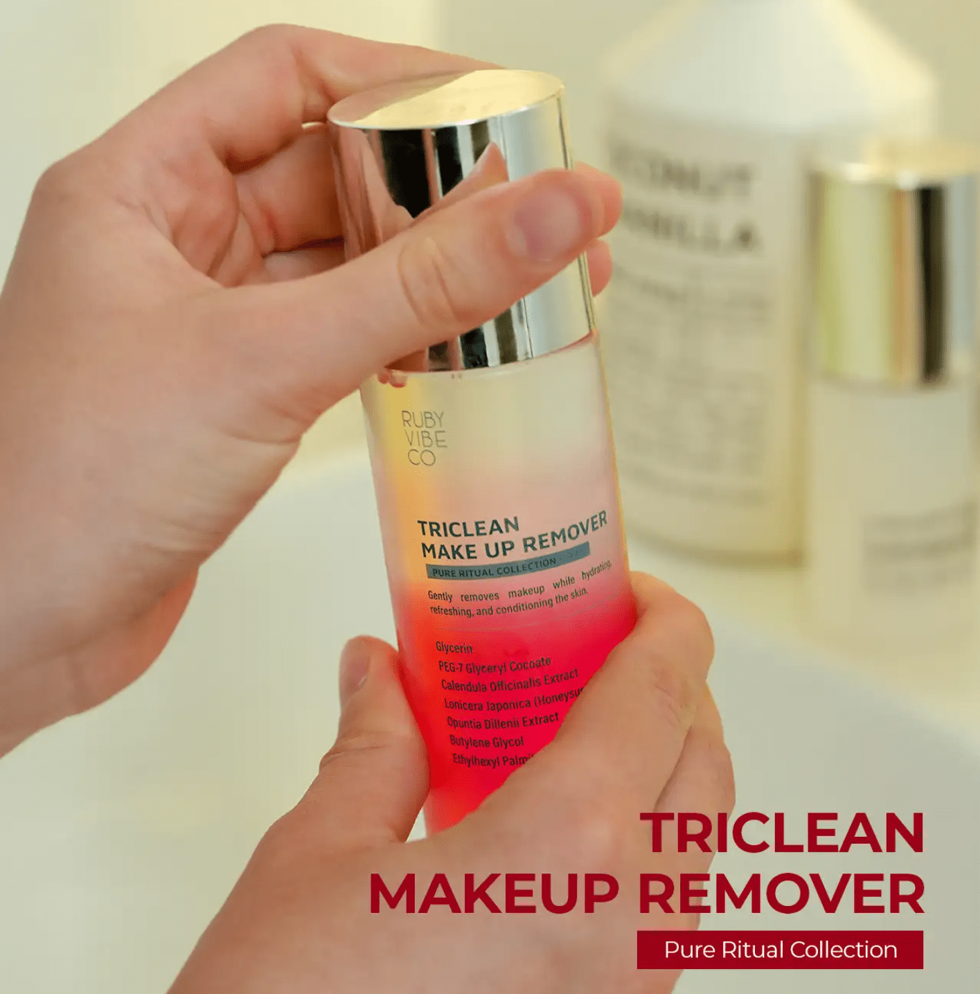 A pair of hands holds a bottle of 'Ruby Vibe Co Triclean Makeup Remover,' highlighting its benefits for gentle and hydrating makeup removal.