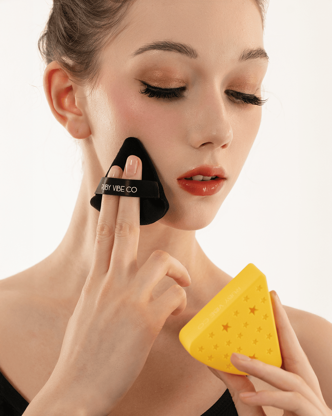 a girl applying Velvet Powder Puffs