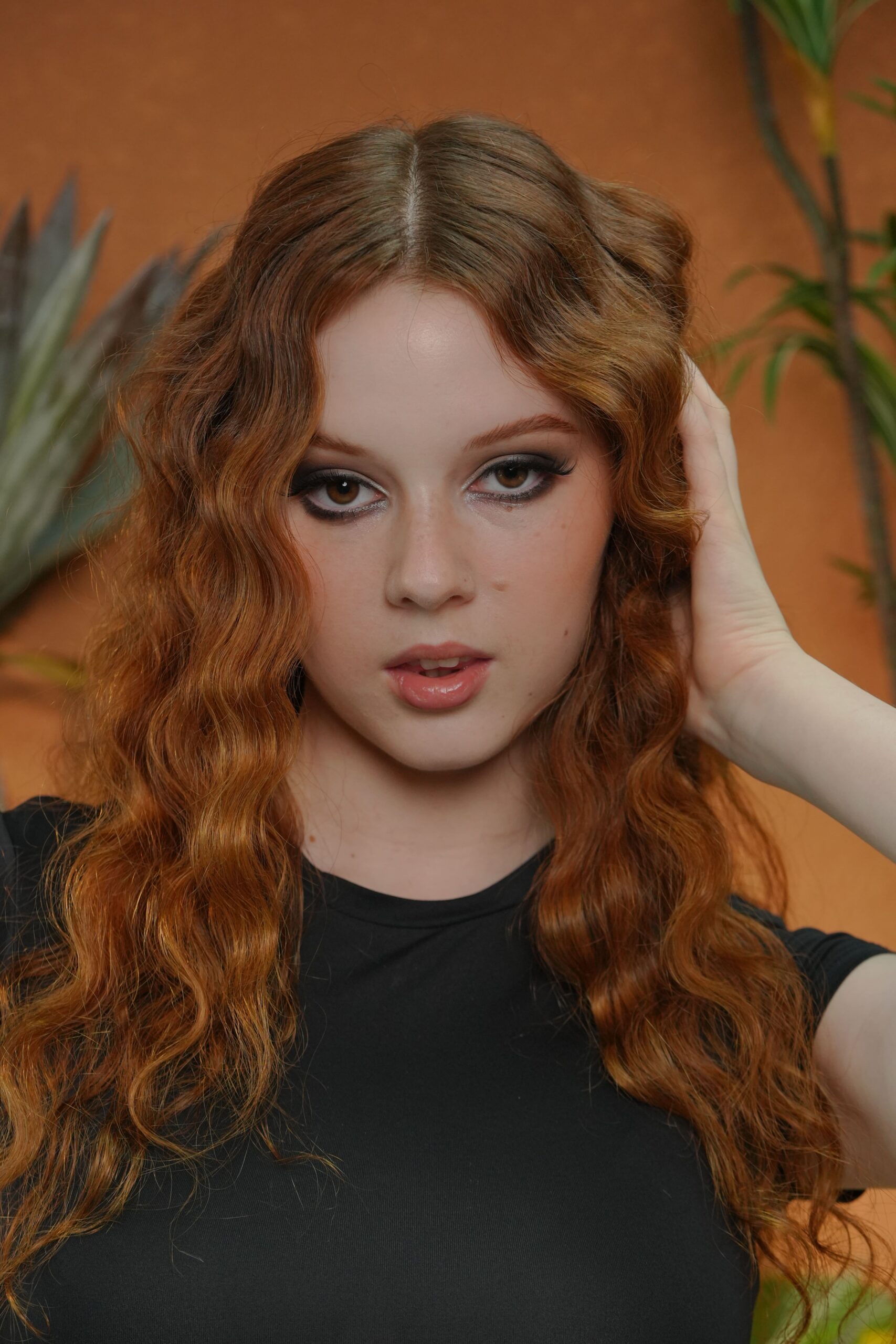 A portrait of a woman with a smokey eye and a glossy nude lip, an elegant example of pairing a dramatic eye with a subtle lip