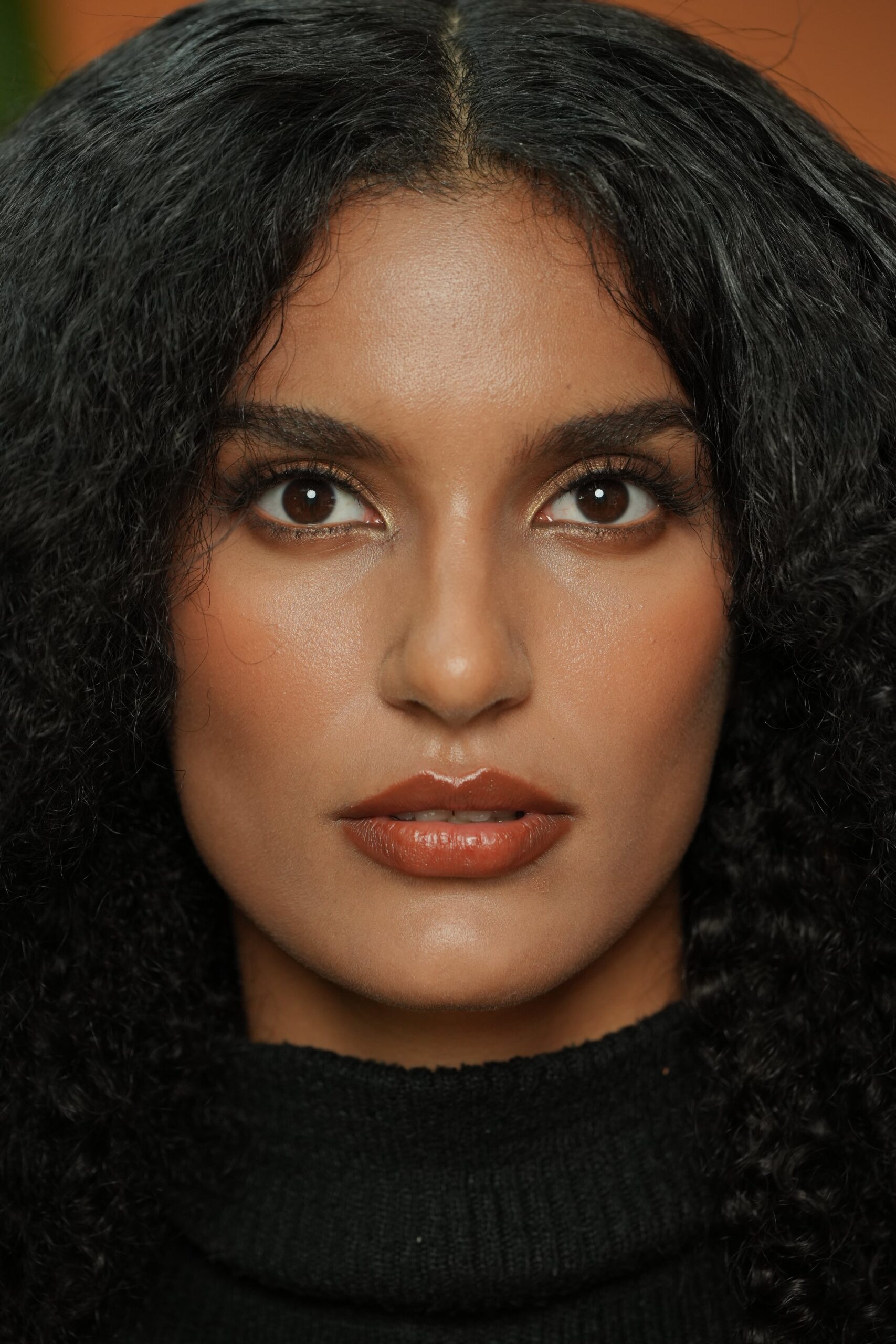 A close-up of a woman with a clean, natural makeup look and a subtle nude lipstick, a perfect example for a casual day styling guide