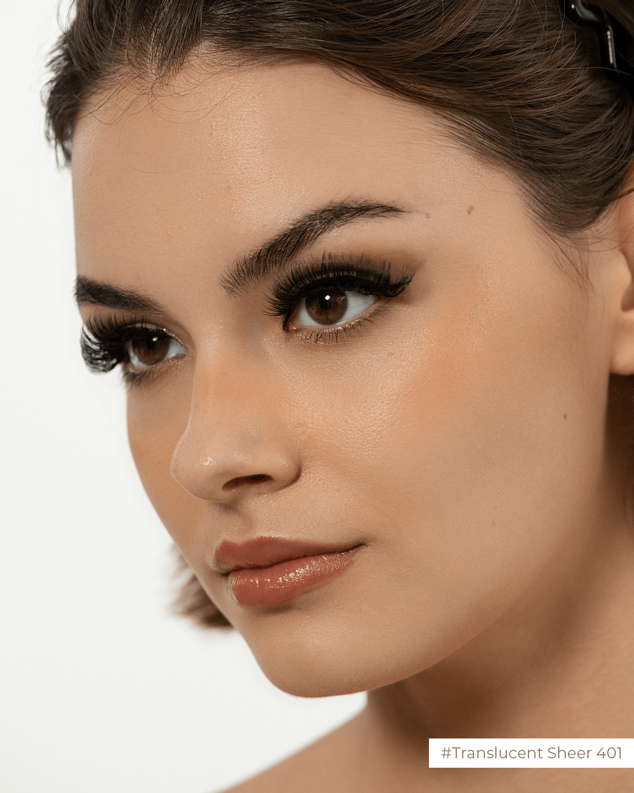 A side-profile of a woman with a 'Translucent Sheer' nude lip gloss, showcasing a dewy, glowing finish.