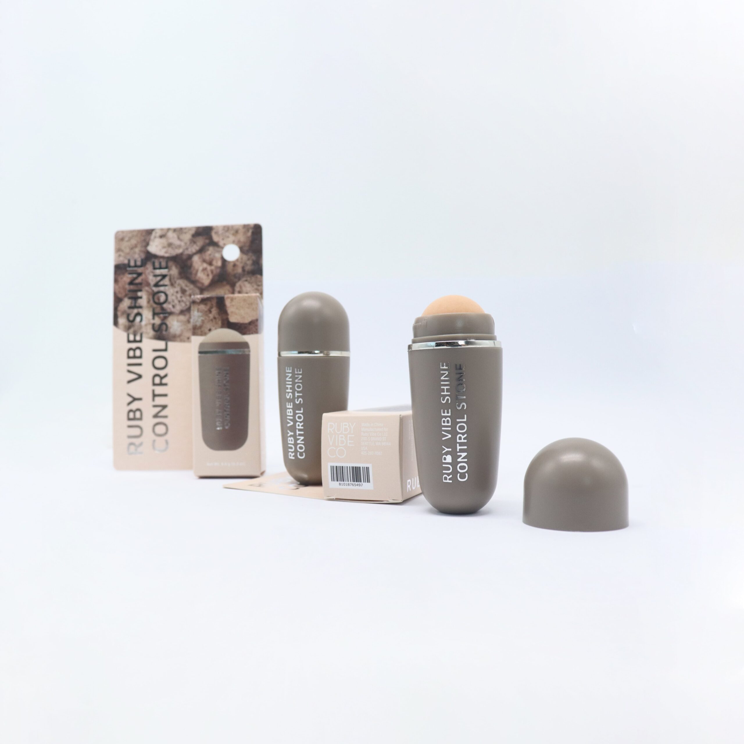 A product shot of 'Ruby Vibe Shine Control Stone,' a specific tool designed to help control shine and create a fresh finish for oily skin.