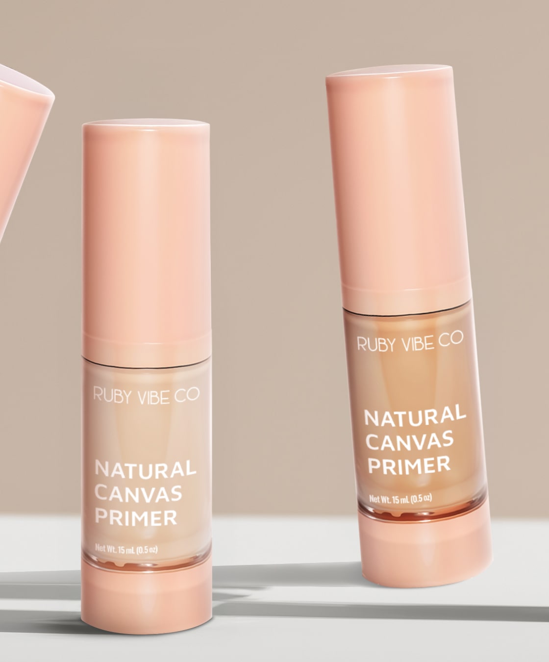 A close-up of two bottles of 'Ruby Vibe Co Natural Canvas Primer' in different shades, essential for a professional makeup kit to prepare skin.
