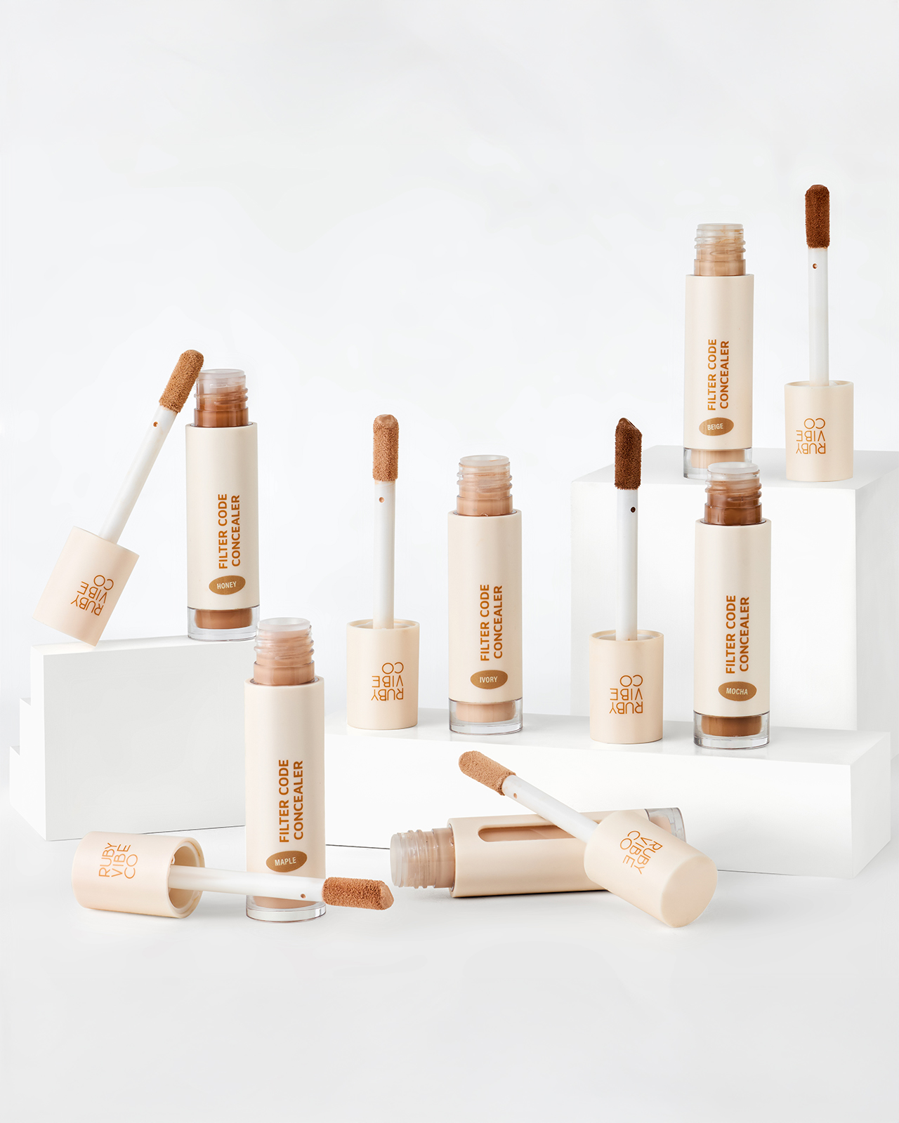 A product display of 'Ruby Vibe Co Filter Code Concealer' in multiple shades, demonstrating the range of colors available for a professional makeup artist's kit.