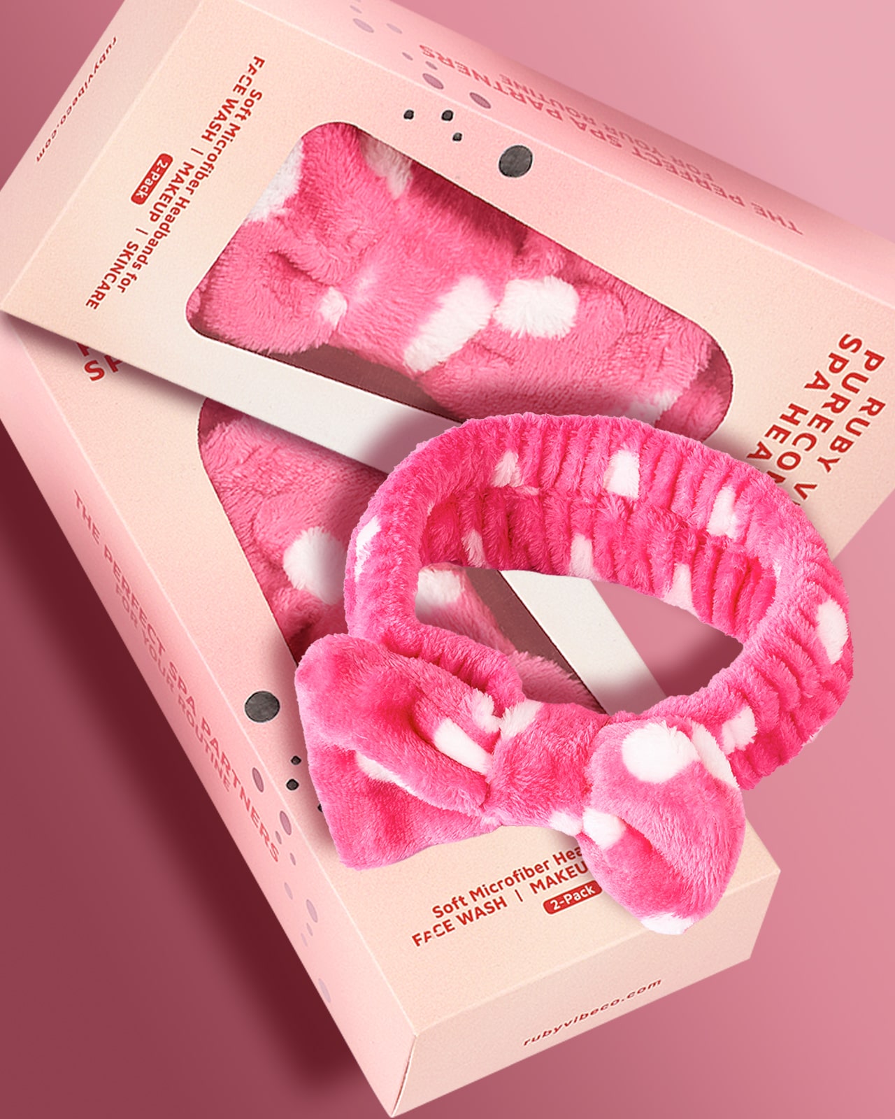 A product shot of a pink, polka-dot microfiber headband and its packaging, a guide to what to look for when buying a skincare headband