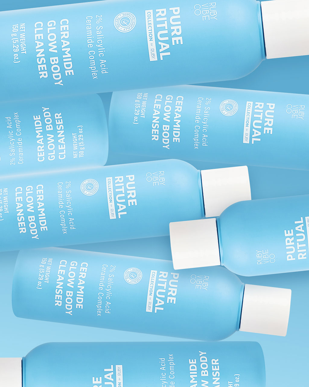 A pattern of several light blue bottles of Ruby Vibe Co's Pure Ritual Ceramide Glow Body Cleanser.