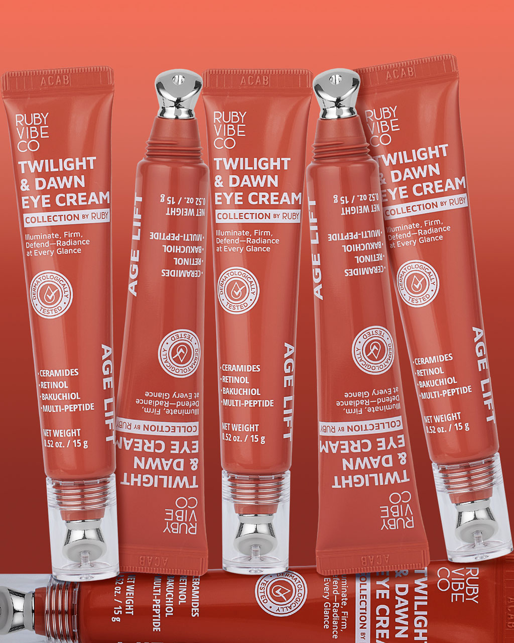 A flat lay composition of several red-orange tubes of Ruby Vibe Co eye cream arranged in a repeating pattern, showcasing the product's packaging.