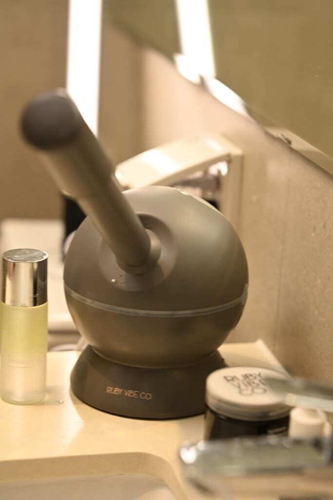 A Ruby Vibe Co facial steamer on a bathroom counter