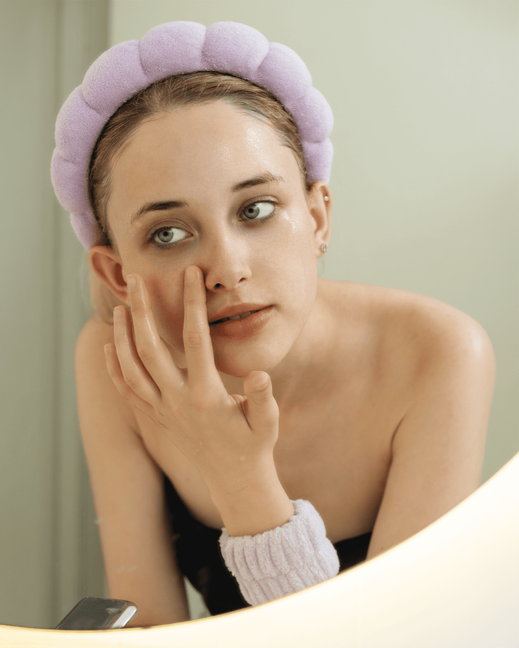 A woman with dewy skin from a cleansing oil