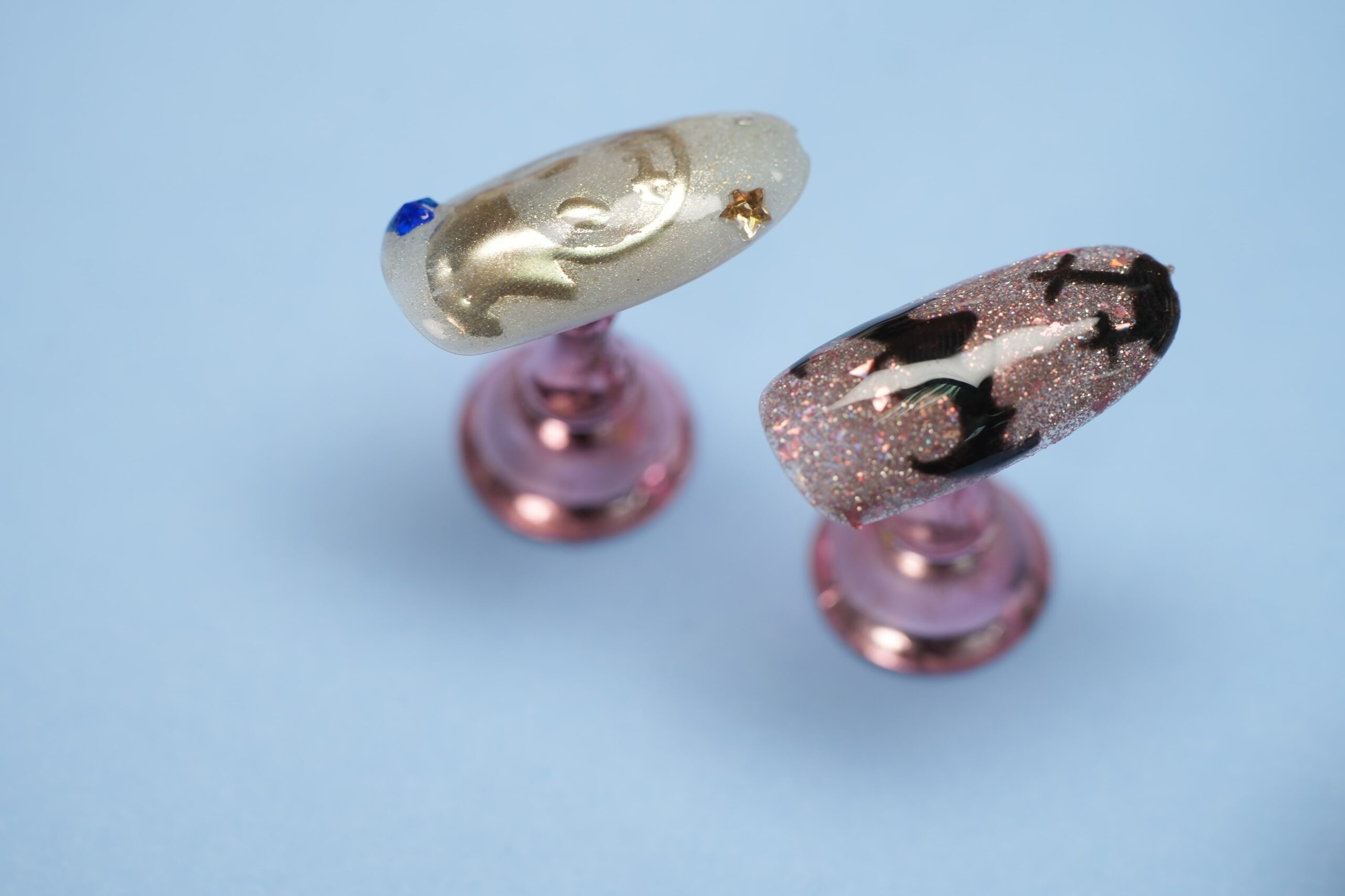 A bold and futuristic chrome nail art idea with 3D-effect silver chrome swirls and shapes on top of a pink base on long coffin nails.