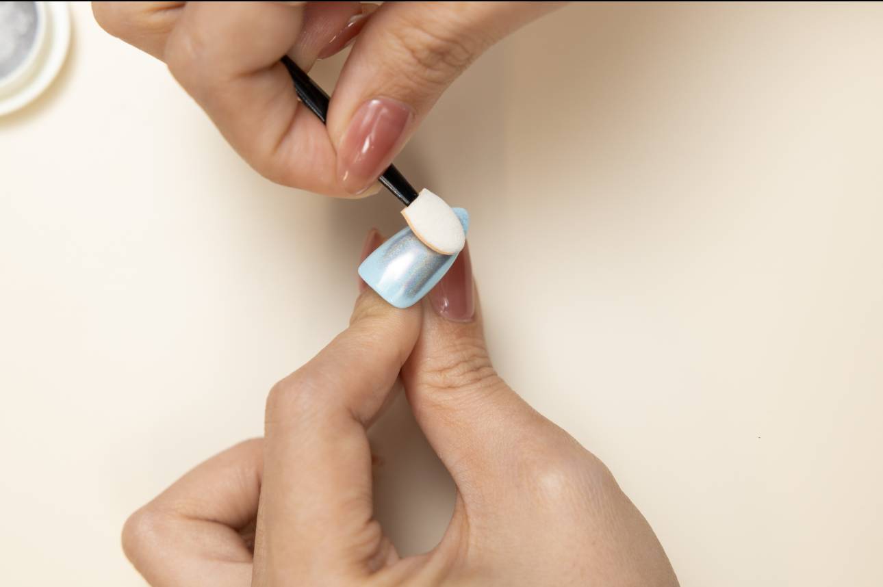 A detailed close-up of a silver chrome nail, emphasizing its flawless, mirror-like reflection, a key difference in the chrome vs holo debate.