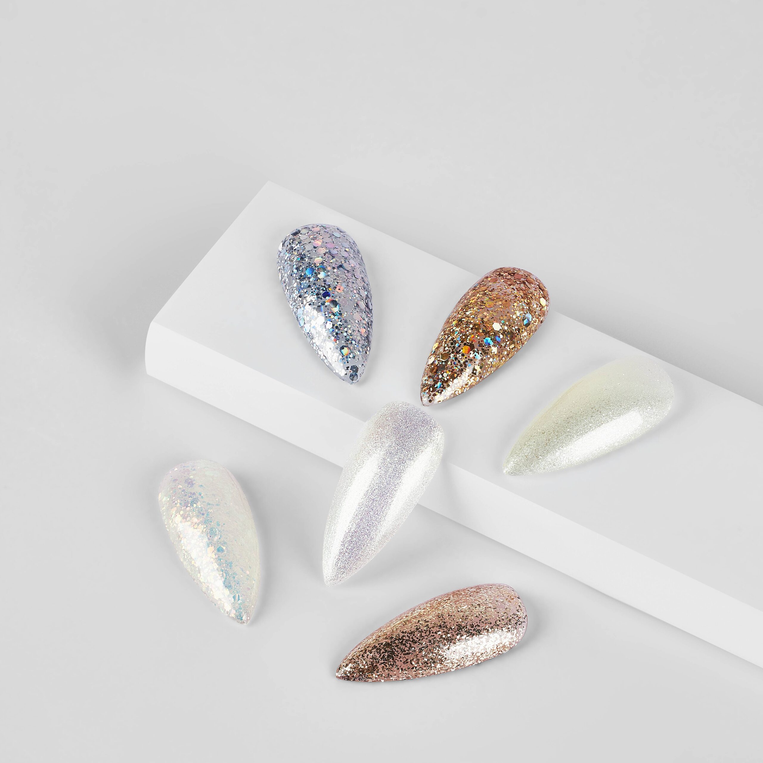 A scattered holographic finish over a black base, creating a galaxy-like effect with multi-colored sparkles, contrasting with a solid chrome look.