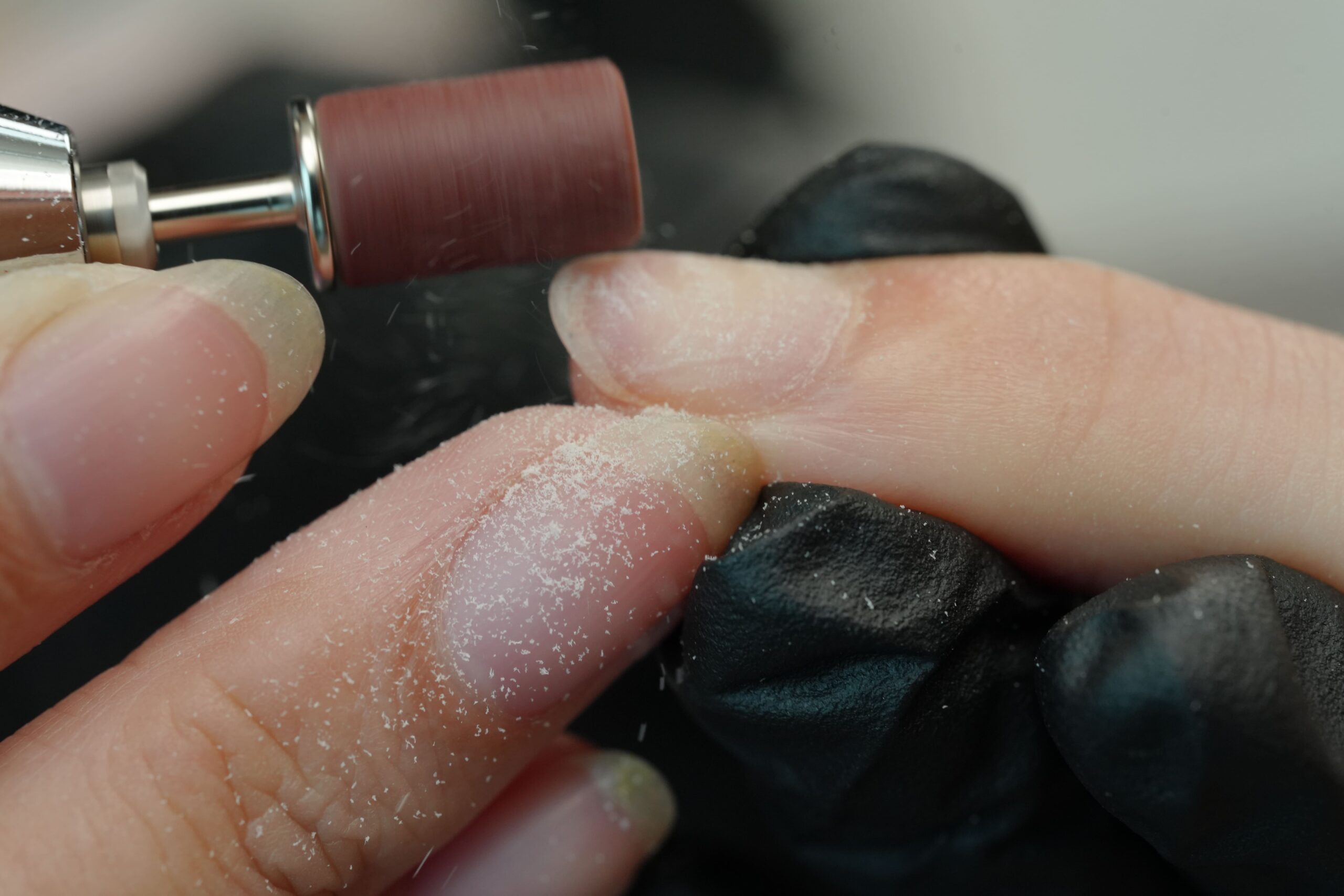 DIY chrome nails: Nail preparation with an electric file to shape and buff the natural nail surface.