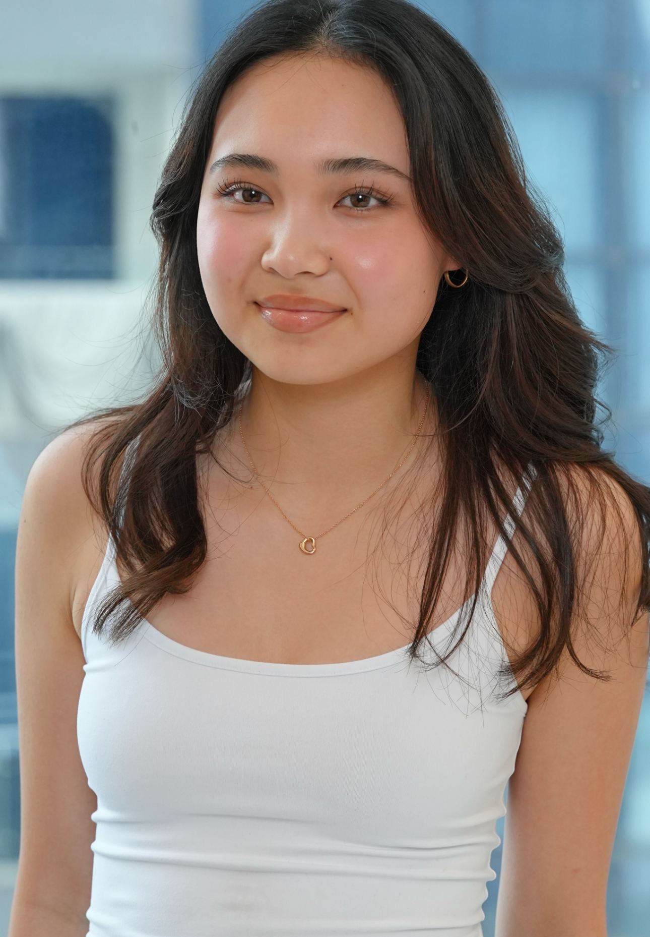 A portrait of a woman with healthy, glowing skin, representing the positive outcome of using the best moisturizers for oily skin.