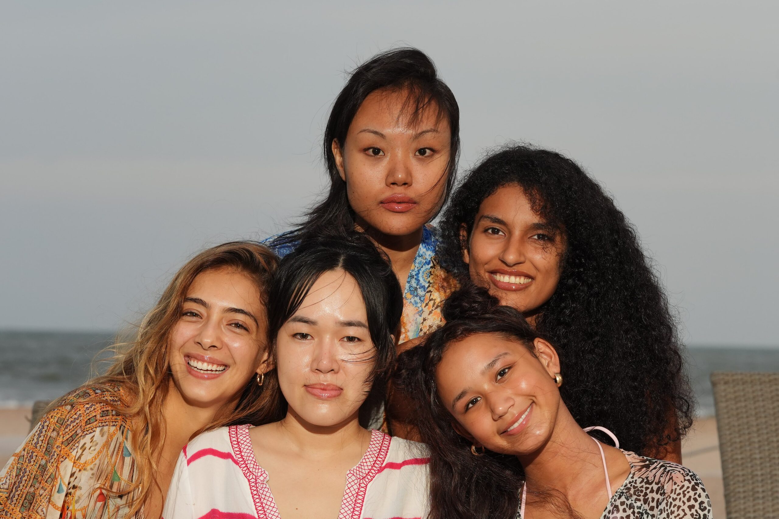 A diverse group of smiling women with healthy, radiant skin, symbolizing the positive results and confidence gained from using the right moisturizer for oily skin.